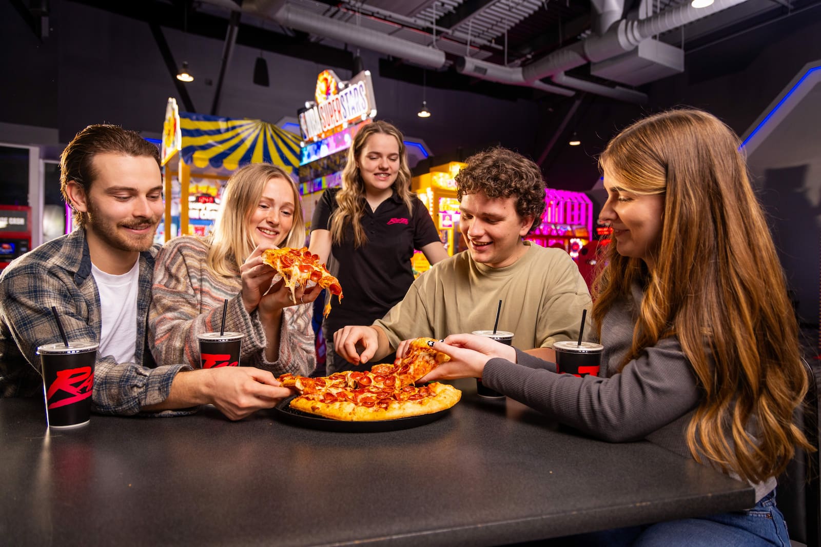 Friends sharing pizza at Rad Tag